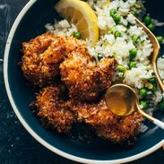 Coconut shrimp in a bowl with rice and peas
