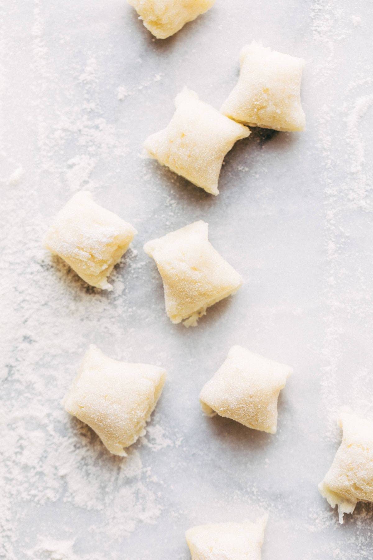 Pieces of gnocchi coated in flour.