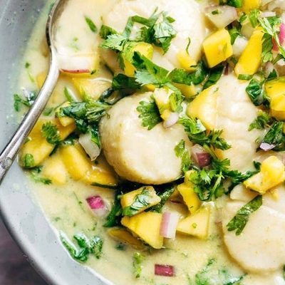 Green Curry Scallops in a bowl with a spoon.