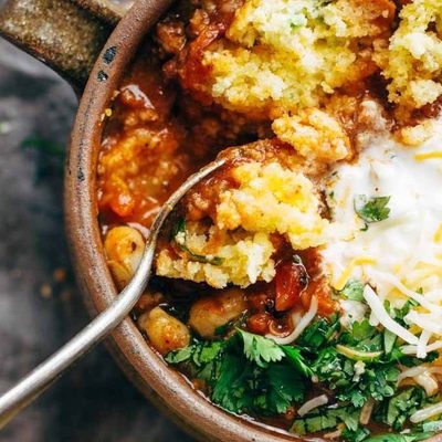 Spicy Posole in soup mug with cornbread.
