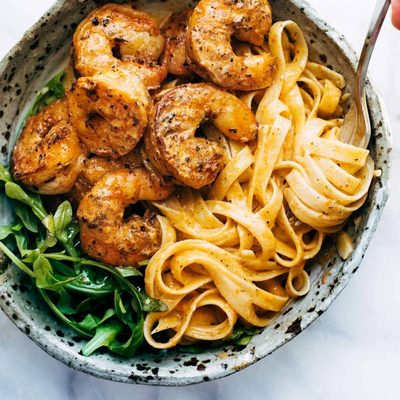 Red Pepper Fettuccine in a bowl with shrimp.