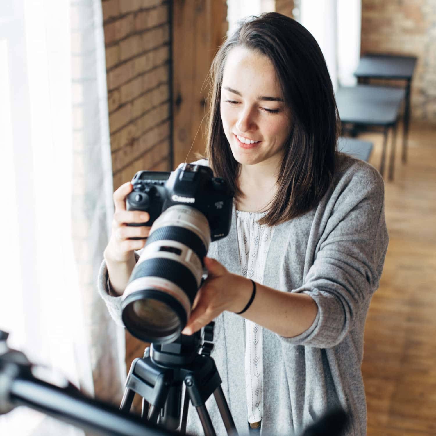Woman using a camera for videography.