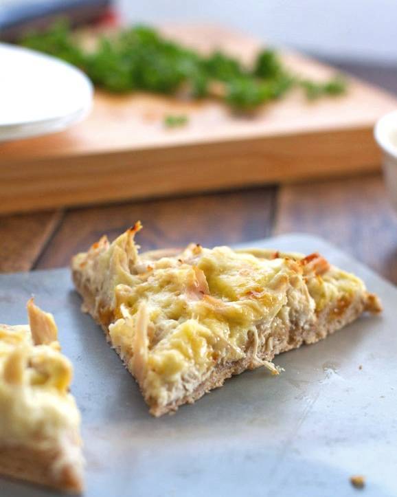 Chicken Alfredo pizza slice.