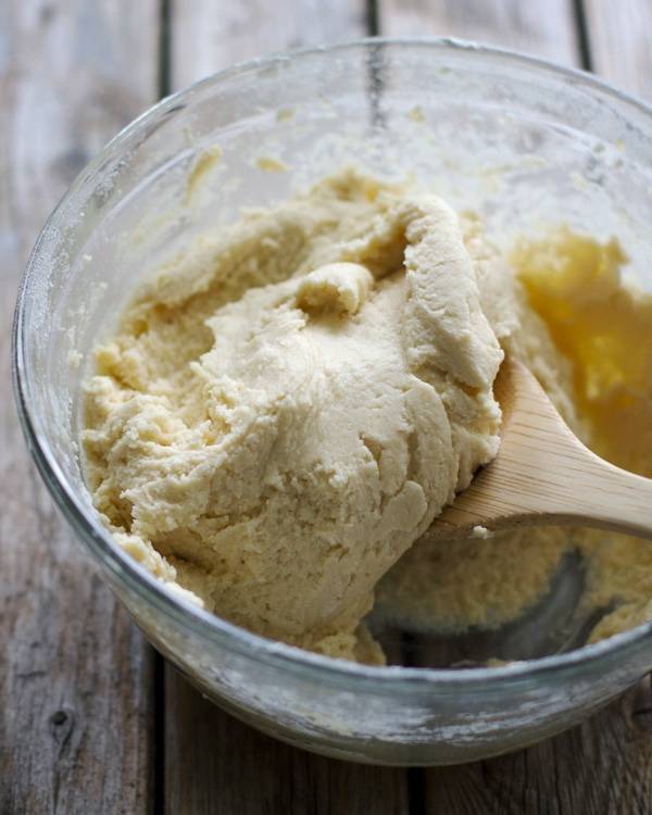 Cookie dough in a clear mixing bowl.