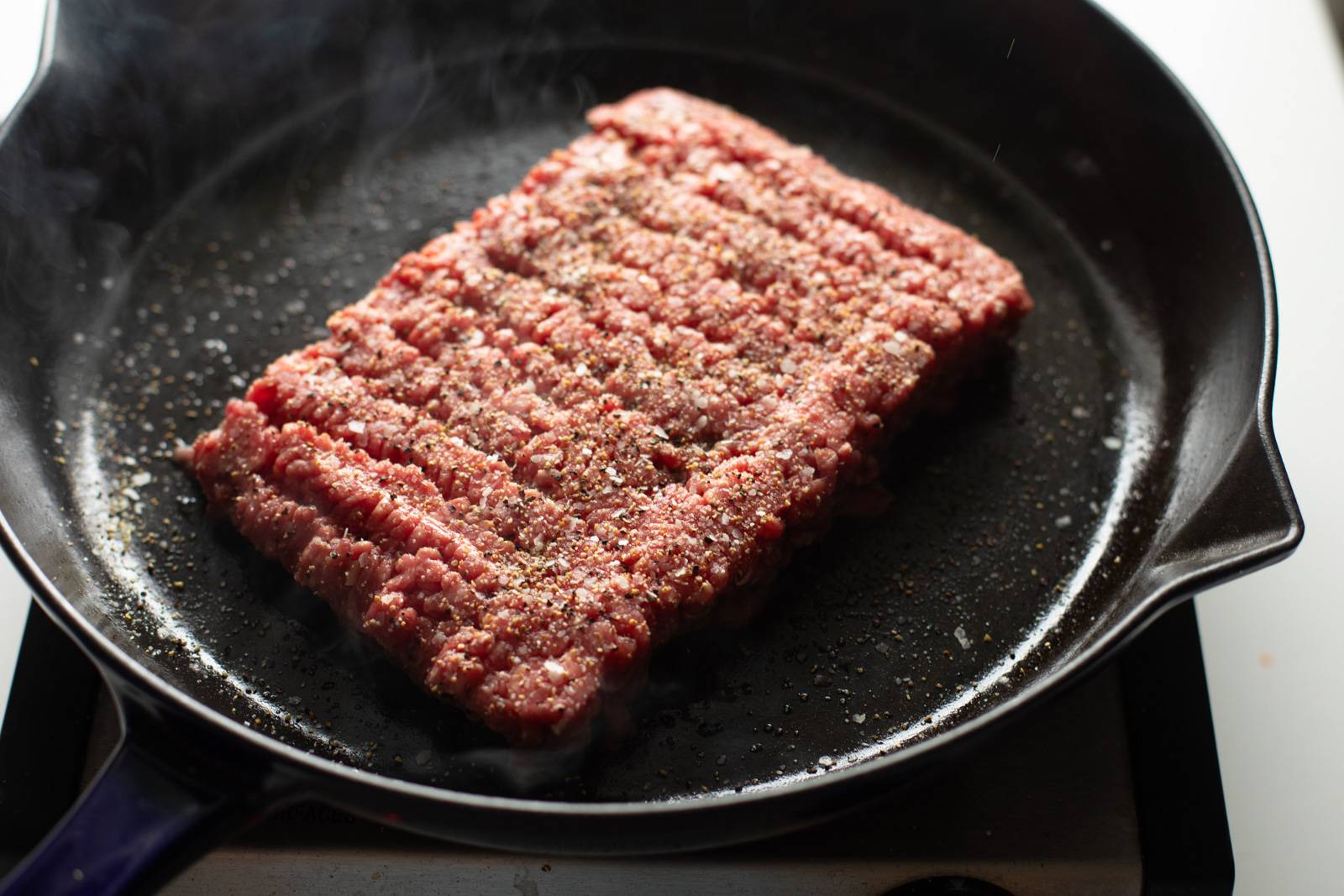 Ground beef in a cast iron skillet.