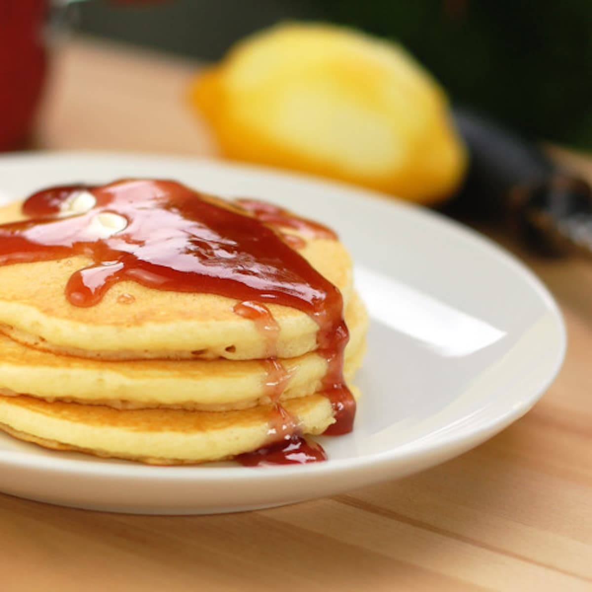 Lemon Pancakes topped with a blackberry syrup made from blackberry jam.