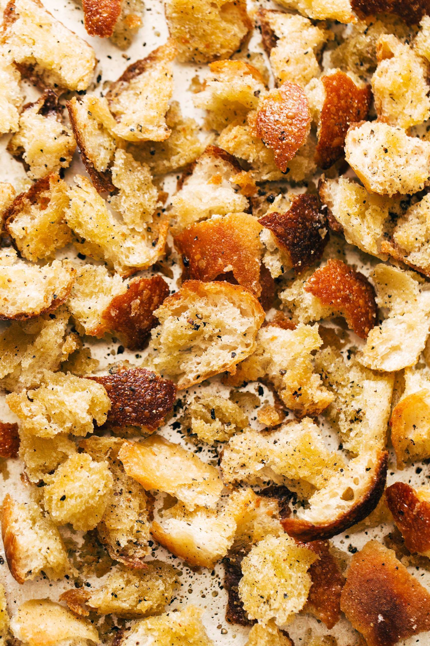 Peppery hand-torn croutons on a sheet pan.