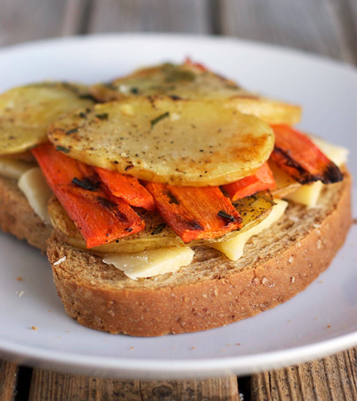 Three cheese grilled cheese open with veggies.