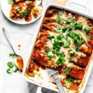 Quinoa Enchiladas in a pan with spatula.